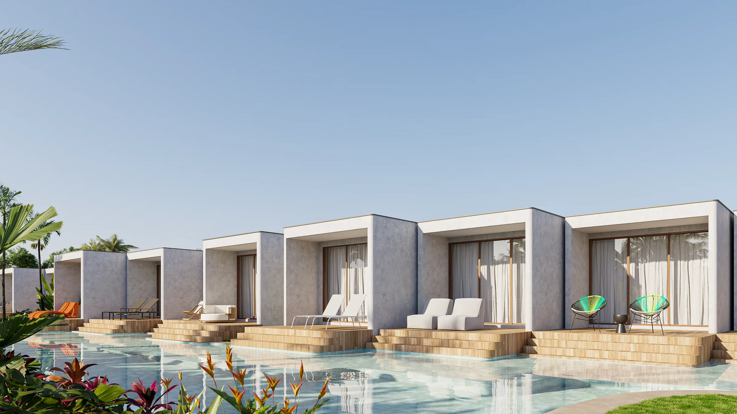 Fileira de lofts de frente para a piscina, com deque de madeira e espreguiçadeiras na beira da água.
